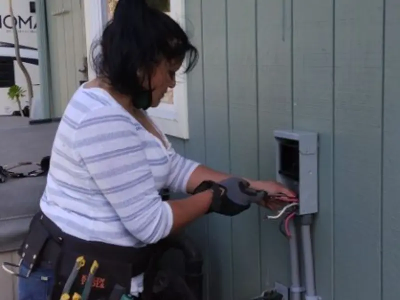 Licensed electrician wiring an exterior subpanel in La Feria